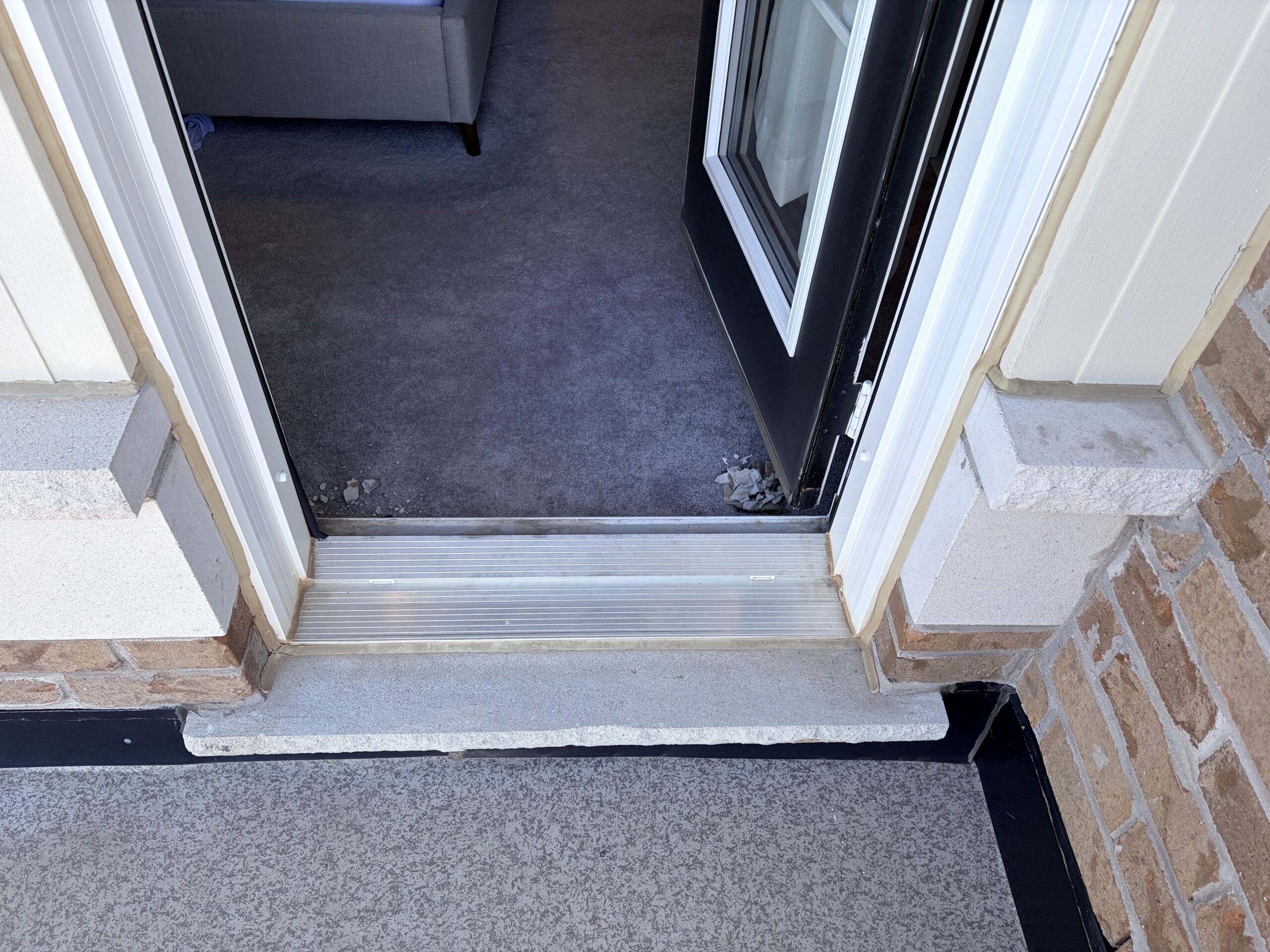 Balcony door water intrusion area repaired after mold remediation in Hamilton.
