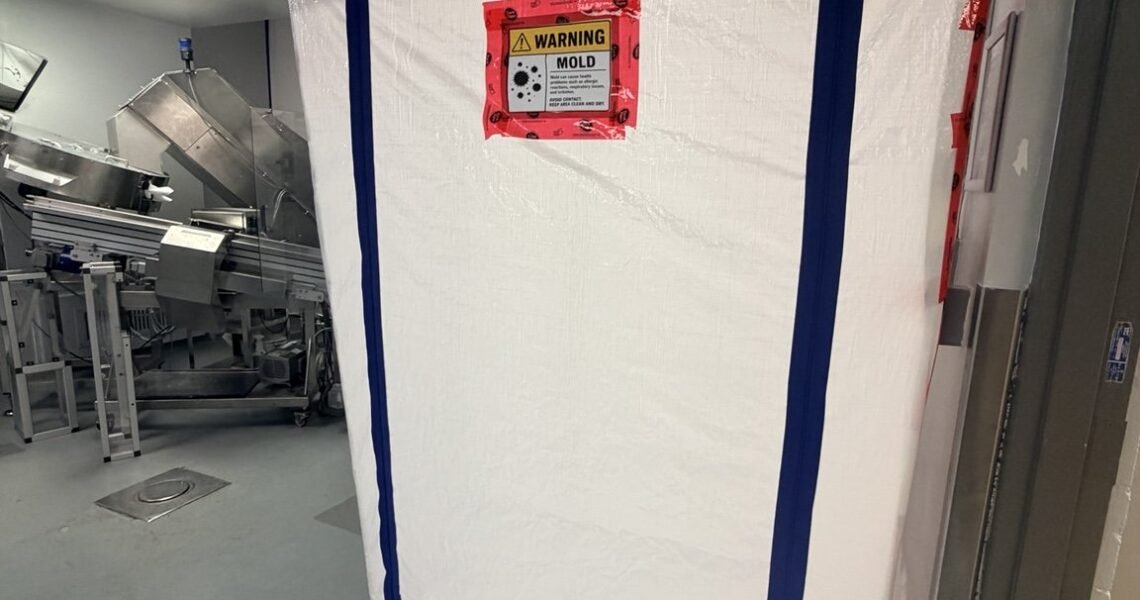 Controlled containment entrance with mold-hazard warning signage