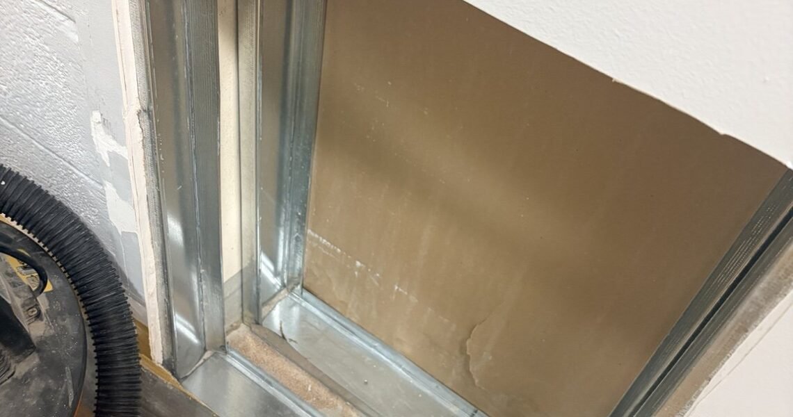Exposed metal framing inside a concealed wall cavity